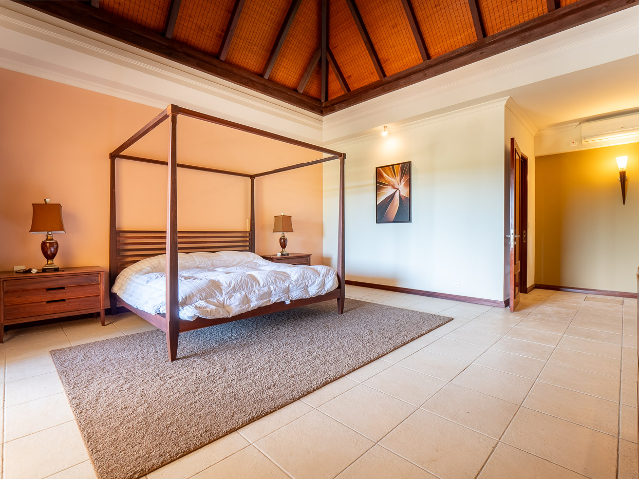 Master bedroom suite with tropical decor in Ohana Heritage Group’s Tamarina property