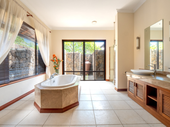 Master bedroom suite with tropical decor in Ohana Heritage Group’s Tamarina property