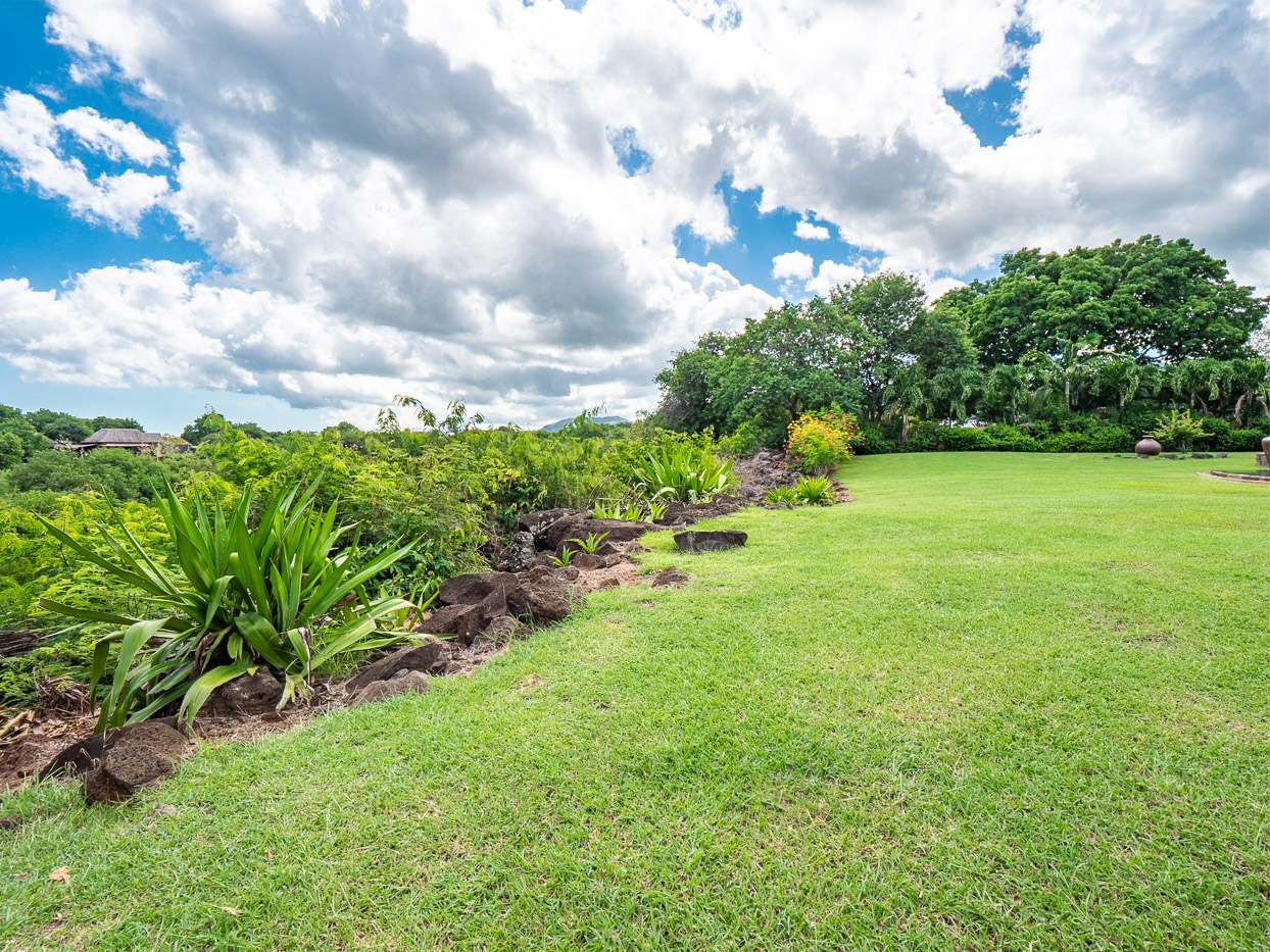Refined exterior with tropical garden and golf views in Tamarina, Ohana Heritage Group