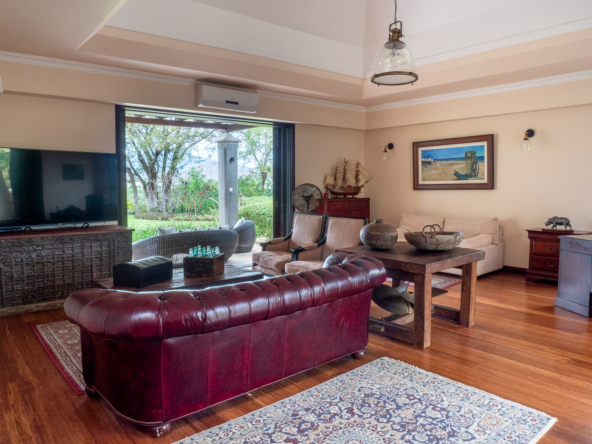 Elegant living room with high ceilings and golf course views in Tamarina property