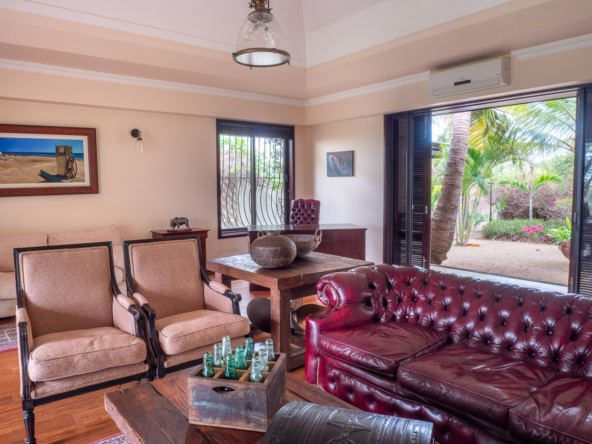 Elegant living room with high ceilings and golf course views in Tamarina property