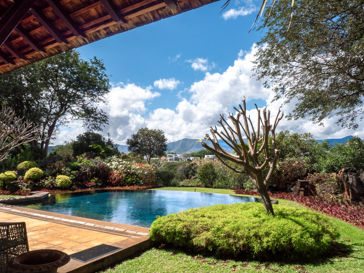 Exclusive villa exterior showcasing expansive terrace and landscaped garden in Mauritius