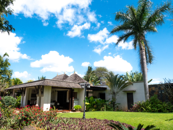 Exclusive villa exterior showcasing expansive terrace and landscaped garden in Mauritius
