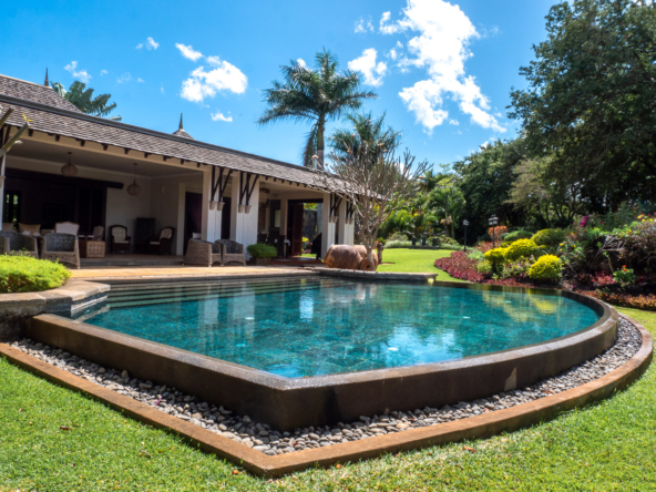 Exclusive villa exterior showcasing expansive terrace and landscaped garden in Mauritius
