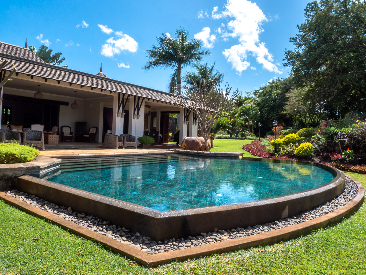 Exclusive villa exterior showcasing expansive terrace and landscaped garden in Mauritius