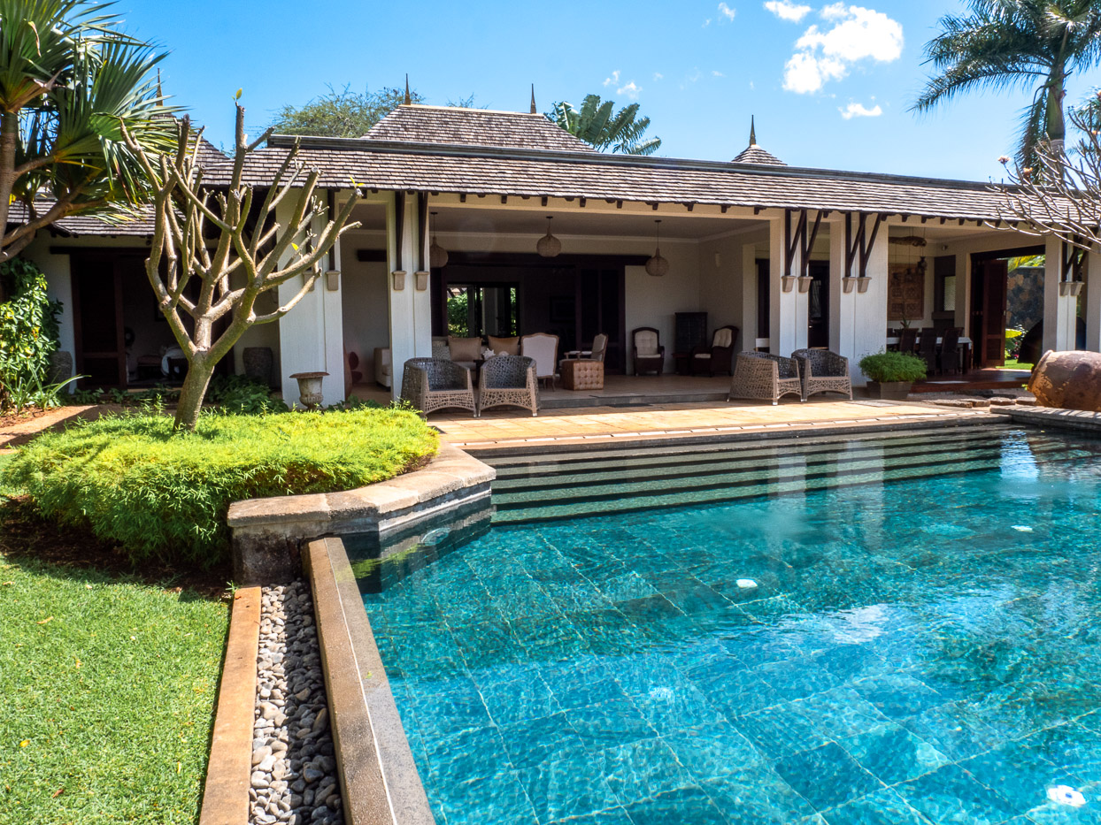 Exclusive villa exterior showcasing expansive terrace and landscaped garden in Mauritius